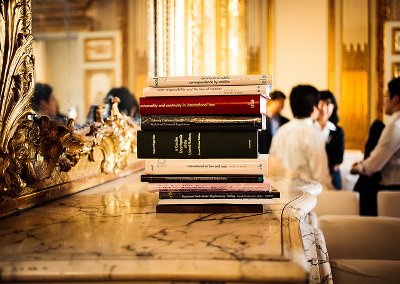 Stack of law books on a marble-topped side table in a Naples room.